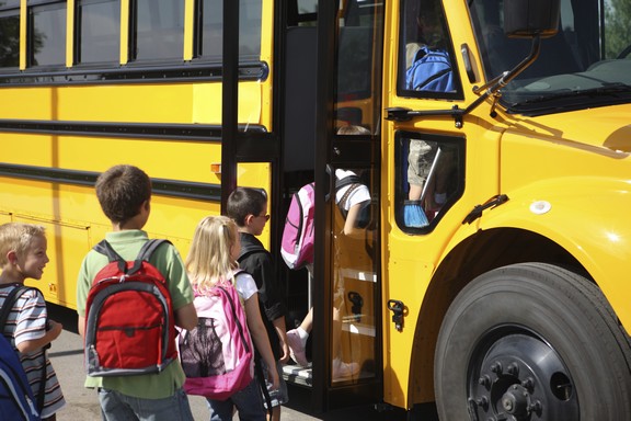 children getting on schoolbus